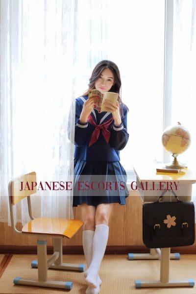 Dada Sexy Asian Escort in Mayfair reading in a study