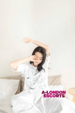 Winnie Asian Cannon Street Escort waking up in bed