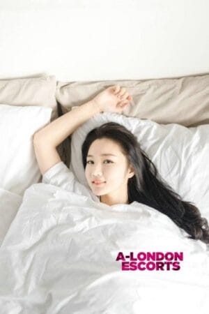 Winnie Asian Cannon Street Escort laid in bed