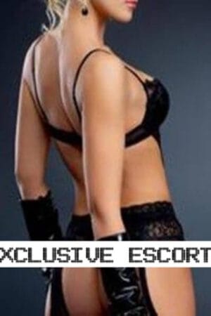 rear view of Brighton escort in black lingerie and gloves