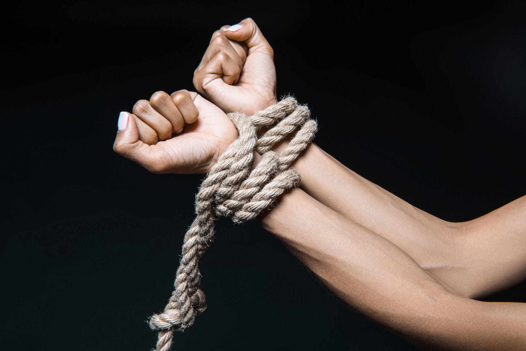 womans hands tied with rope