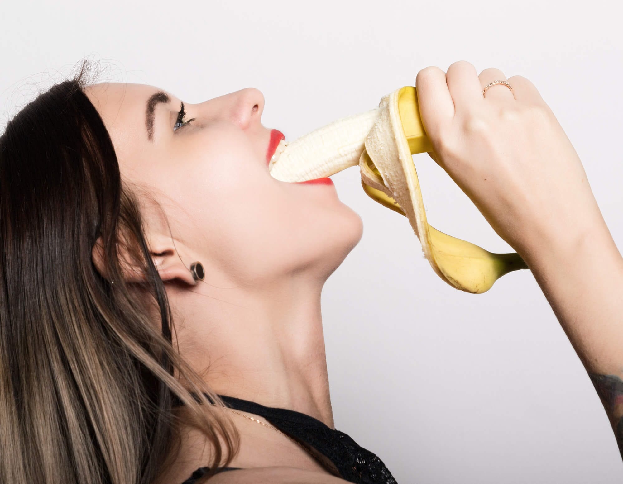 woman deep-throating a banana