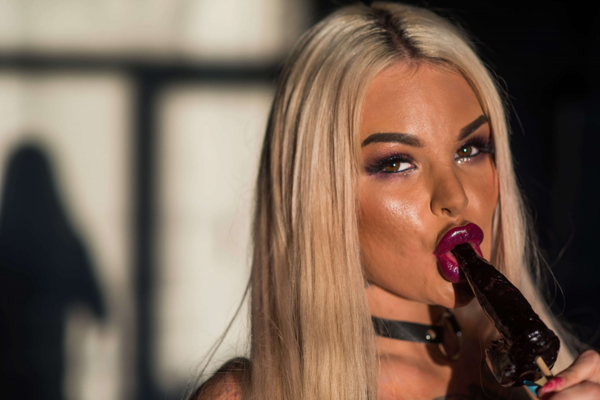 woman sucking a penis shaped lolly