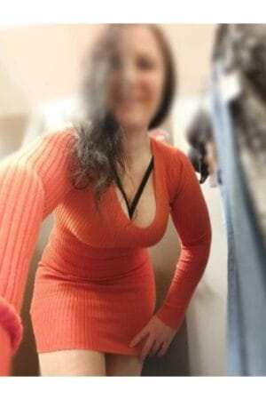 Luton escort looking busty in a orange dress