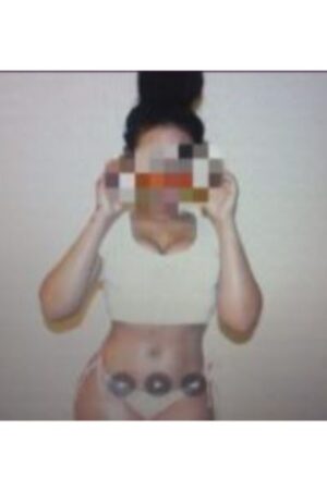 Peterborough escort wearing cream vest and a thong