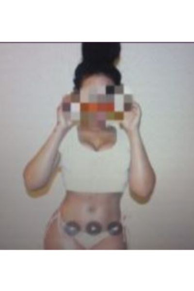 Peterborough escort wearing cream vest and a thong