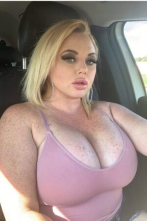 blonde Glasgow escort with big boobs in pink vest