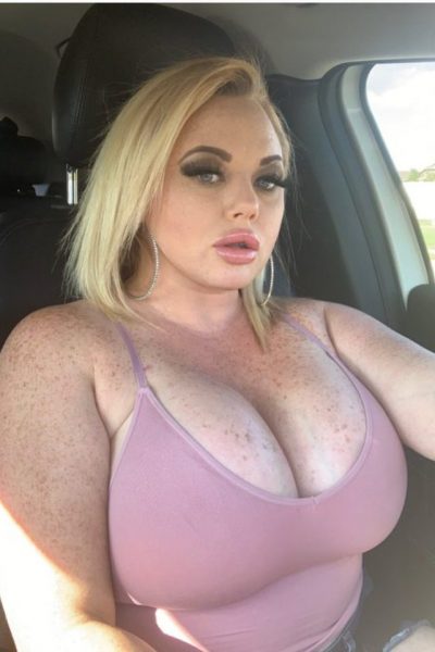 blonde Glasgow escort with big boobs in pink vest