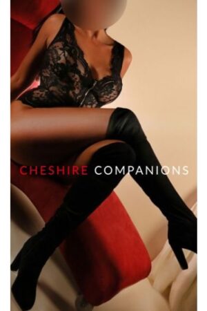 Manchester escort in high heeled platform boots with legs crossed