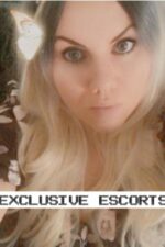 blonde Essex escort with butterfly looking at the camera