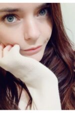 young Manchester escort with her hand on her face