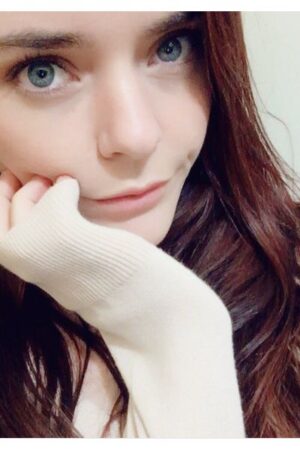 young Manchester escort with her hand on her face