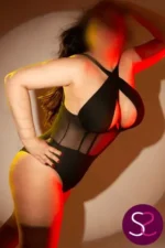 Busty Manchester Escort in a stylish black bodice