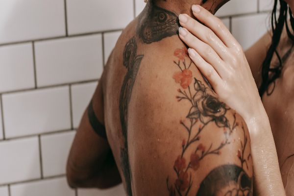 woman caressing tattooed partner