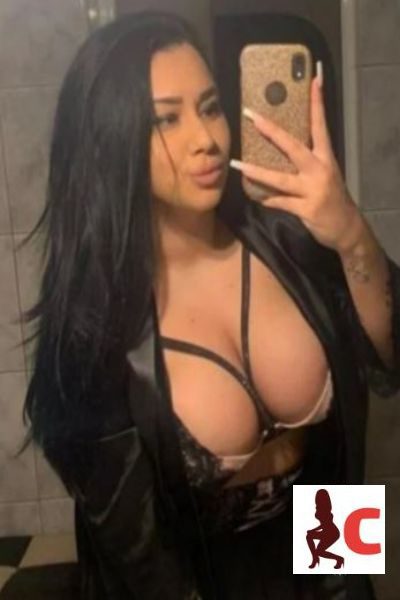 busty Belfast escort shows her big cleavage