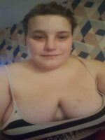 big breasted Newcastle escort in a striped top