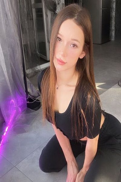 young Asian Bristol Escort kneeling over on floor