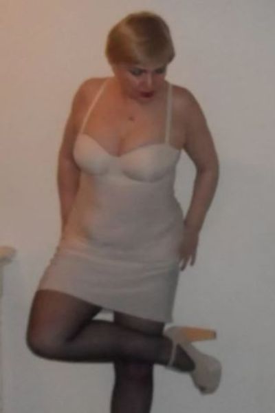 mature blonde Plymouth escort in black stockings and high heels