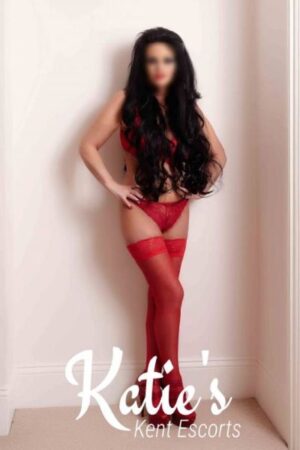 long haired brunette Kent escort in striking red lingerie