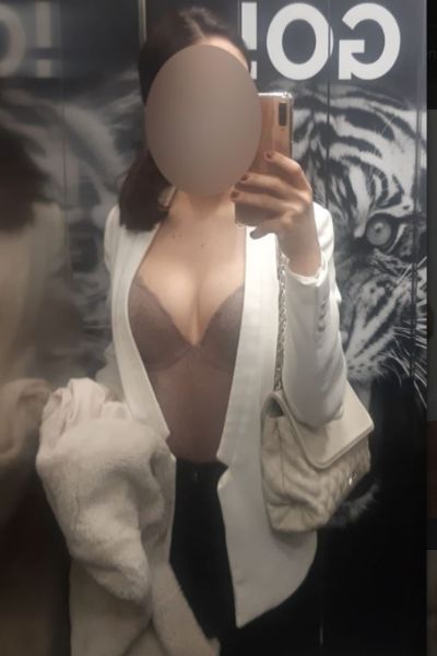 Carlisle escort posing in professional office outfit