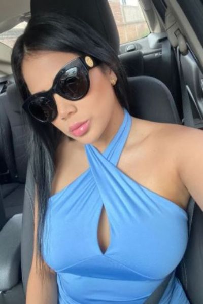 pretty Blackpool escort in blue outfit driving her car