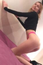 young blonde Bradford Escort kneeling on bed in pink knickers