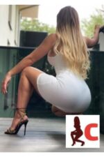 shapely Glasgow escort in high heels and white dress