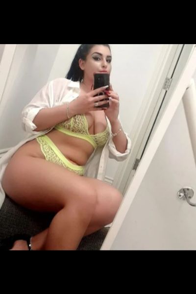curvy Nottingham escort in over sized shirt and yellow lingerie