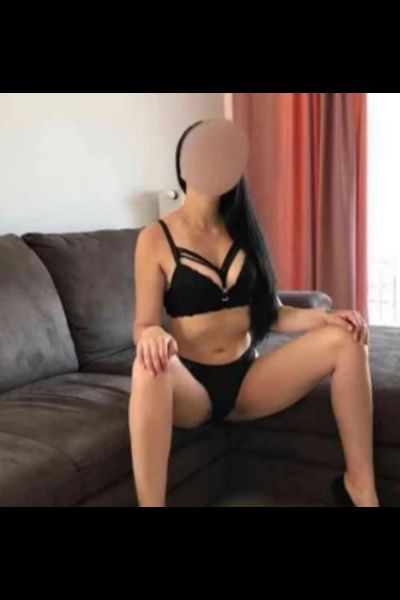long haired Crawley escort straddling the settee