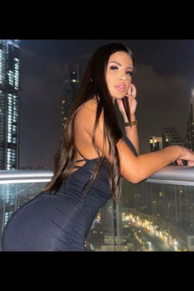 sexy outcall Bristol escort poses over city balcony