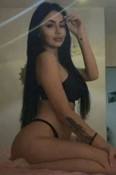 raven haired Bristol Escort showing her arm tattoo