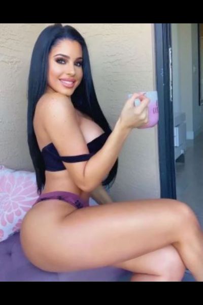 gorgeous dark haired Aylesbury escort drinking tea