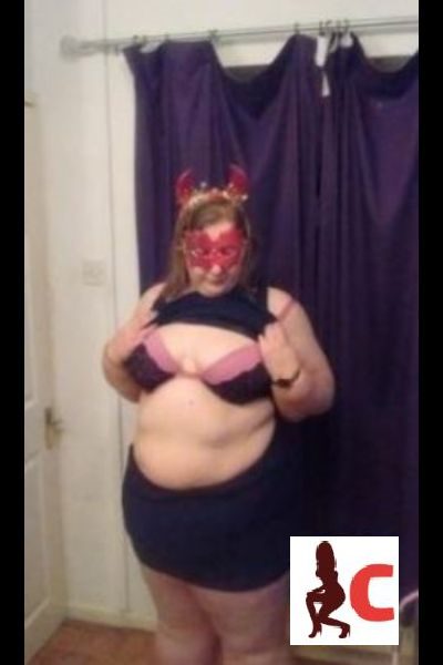 Curvy Wrexham escort lifting top in mask