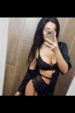 Outcall Milton Keynes escort in black lingerie taking a selfie