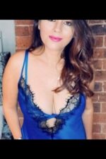 busty brunette Bradford escort in low cut blue top