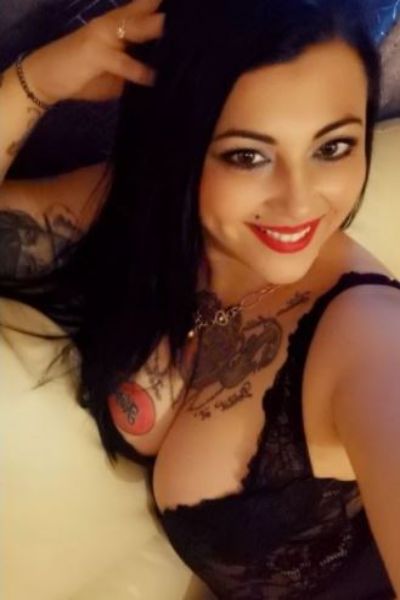tattooed and busty raven haired Ipswich escort