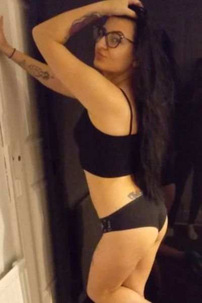 Tattooed Derby Escort wearing glasses