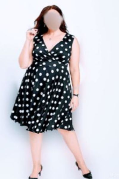 Curvy Luton escort wearing a white polka dot black dress
