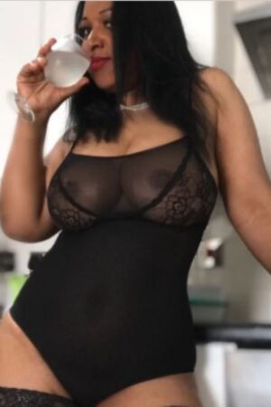 Chelmsford escort in black top drinking from wine glass