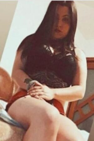 young Blackburn escort posing on a chair