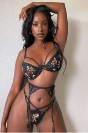 Beautiful mocha Brighton Escort posing in floral underwear