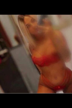blurry selfie of blonde Brighton escort in red undies