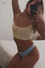 fit young Essex escort in a yellow halter top