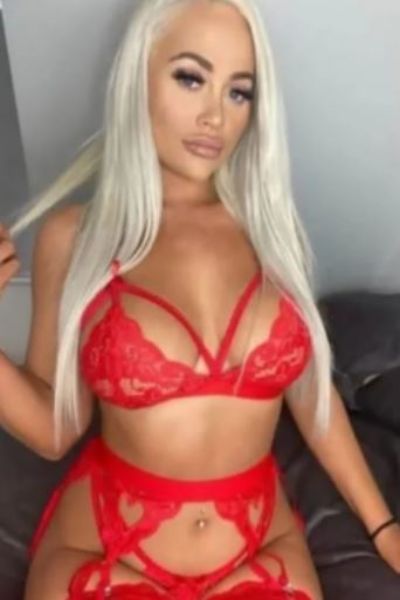 blonde Norwich escort made up in red sexy lingerie
