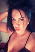 Kelly London Latina Escort in a black bra