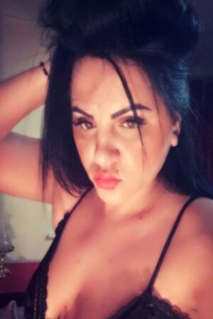 Kelly London Latina Escort in a black bra