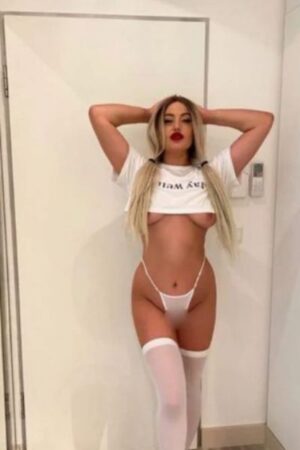 Busty Reading escort showing nipples under a halter top