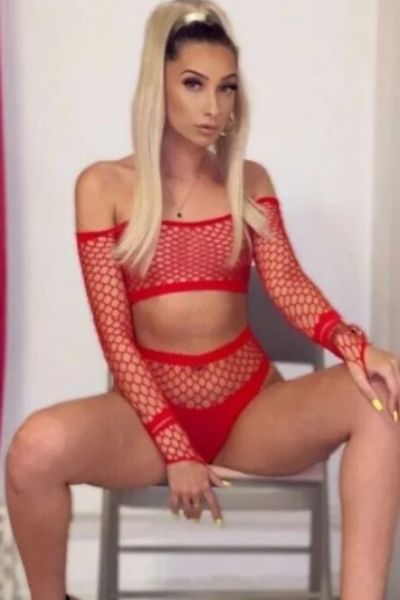 Hot tanned Reading escort in red fishnet outfit