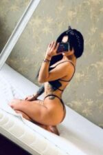 tattooed Sunderland escort taking a selfie in a thong
