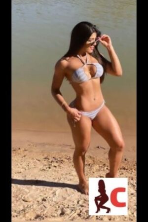 hot brunette Tyrone escort poses on the beach